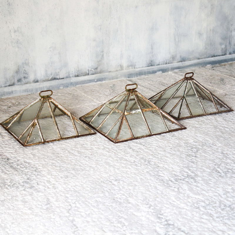 Set of three Victorian iron and glass pyramid garden cloches