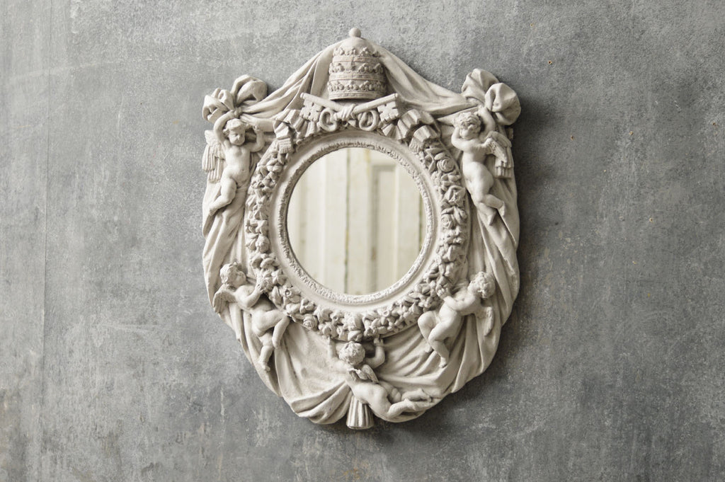 An Italian mirror moulded from a Vatican window.