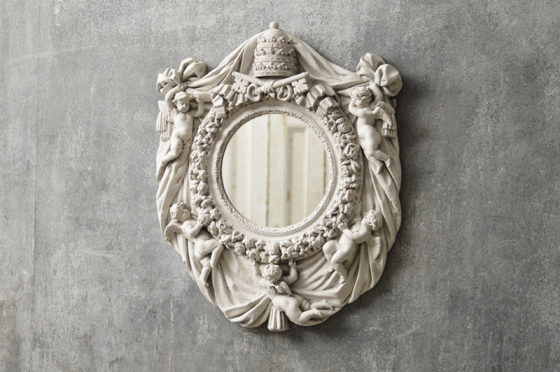 An Italian mirror moulded from a Vatican window.