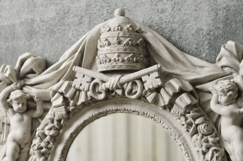 An Italian mirror moulded from a Vatican window.